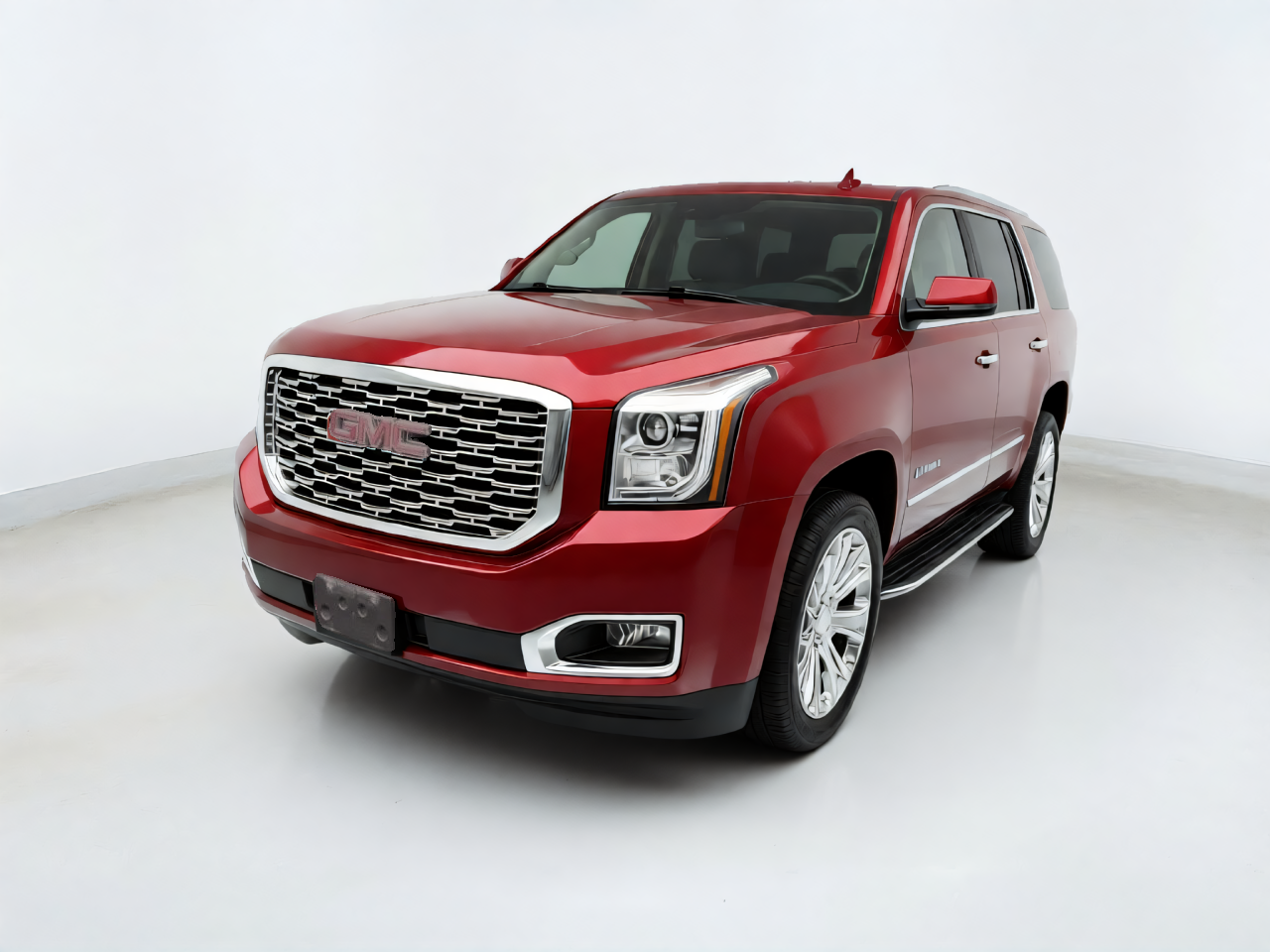 Red GMC Yukon photographed in a clean virtual studio